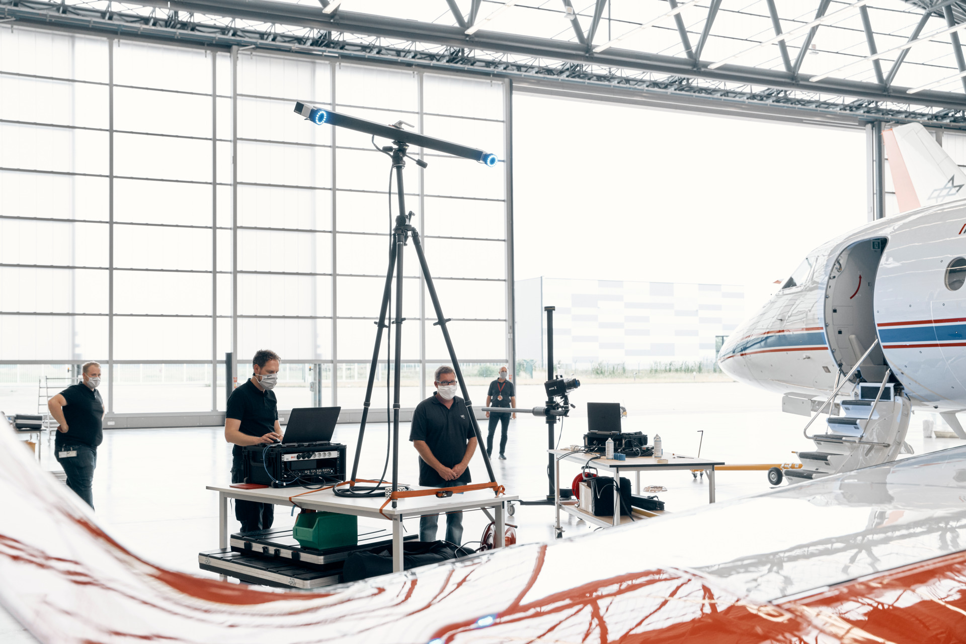 Industrial ARAMIS optical measurement setup beside a large aerospace structure