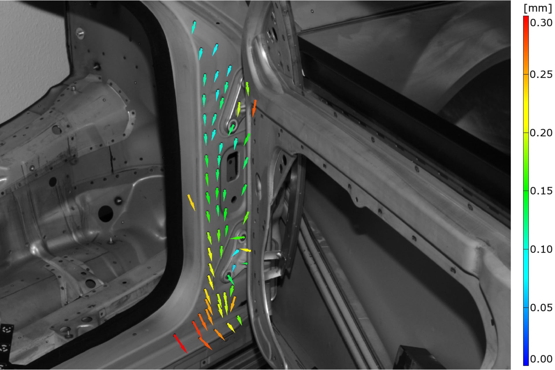 Vehicle A-pillar displacement vectors under loading, with a colour scale in millimetres